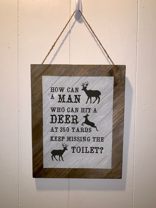 How Can a Man Who Can Hit A Deer At 250 Yards Keep Missing The Toilet Wooden Sign